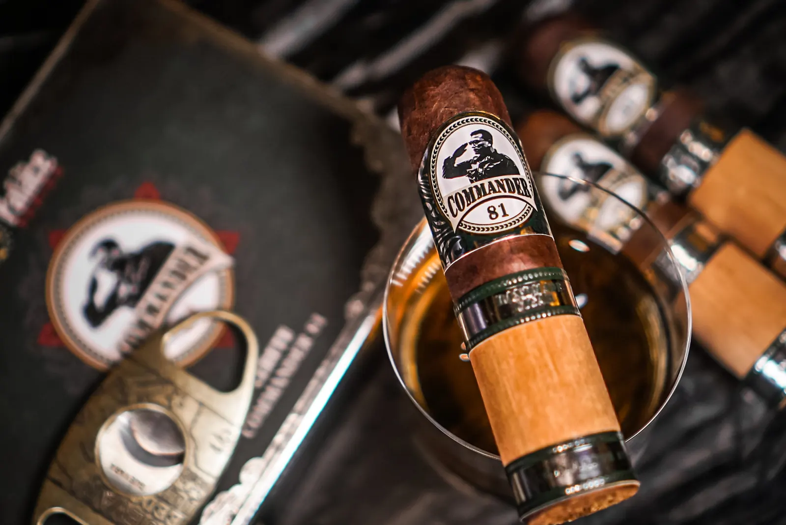 A cigar cutter beside a Commander 81